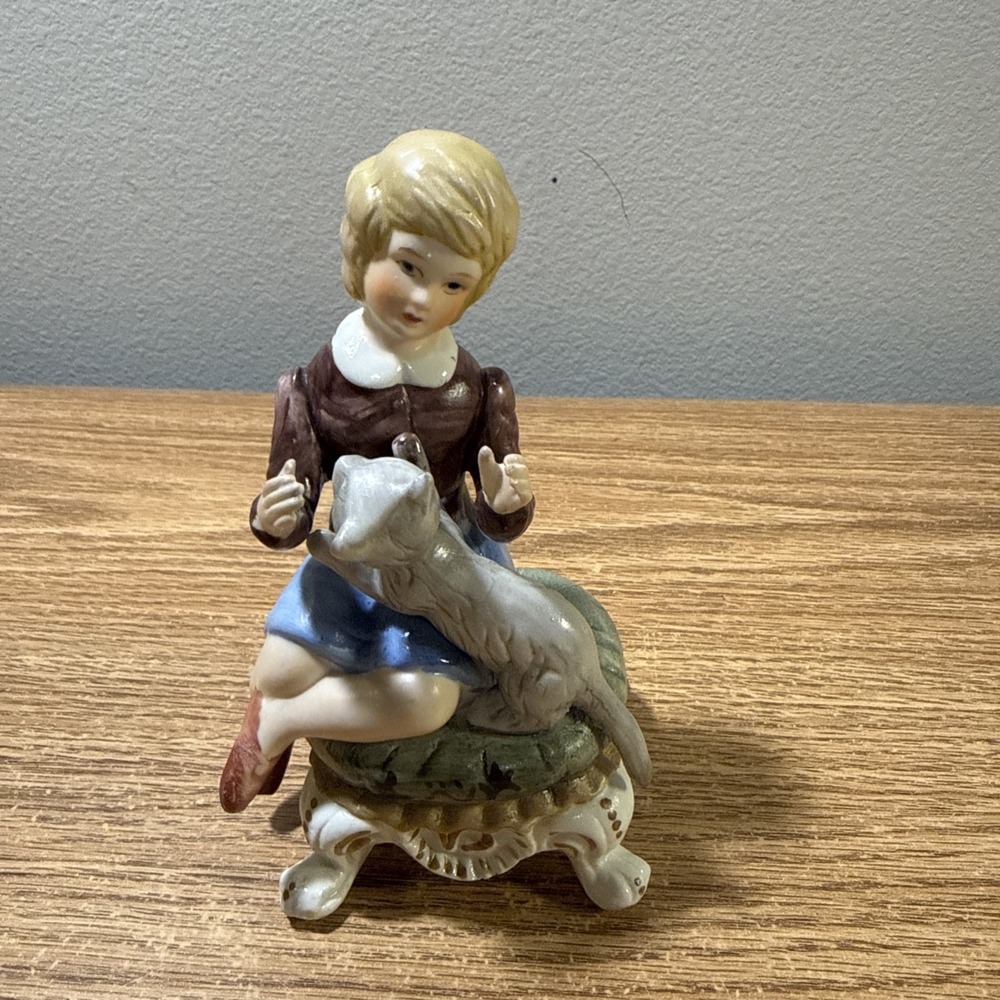 The Girl With The Cat Figurine